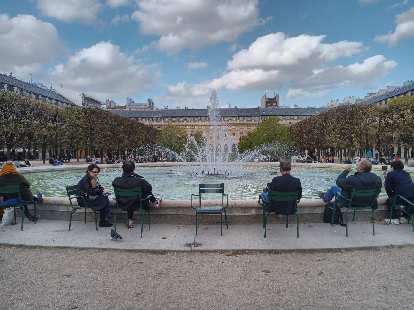People relaxing around the fountain at the Palais-Royal. People relaxing around the fountain at the Palais-Royal.