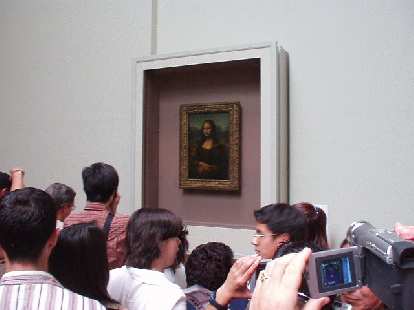[Louvre] At last, I see the Mona Lisa!!  Note the huge crowd around it, including many people who seemed to walk right by the other exhibits without giving so much as a glance.  It is a great painting, though, exuding both beauty and intrigue.