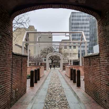 This passageway led to Ben Franklin's home, which is depicted by the "ghost arches."