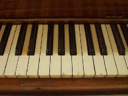 After I tuned the piano (several hours), I turned my attention to aesthetics.  Here is a "before" shot of the chipped and faded keytops.