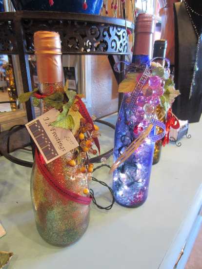 Wine bottles with holes drilled in them for inserting x-mas lights.