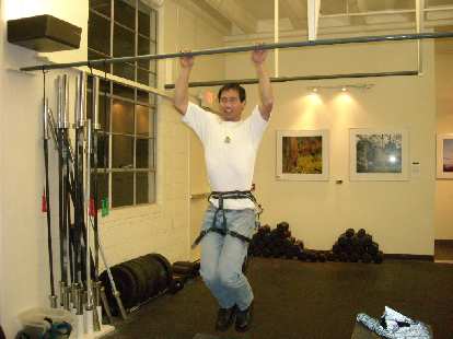 Felix Wong doing weighted pull-ups.