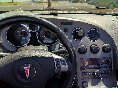 I love the basic, yet stylish, dashboard of the Pontiac Solstice GXP featuring round gauges, vents, and knobs.