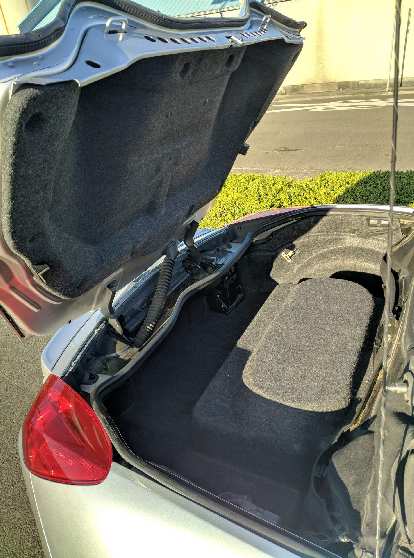 With the top up, the Pontiac Solstice GXP's trunk has a little more room but you'd still be hard-pressed to fit a suitcase in there.