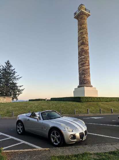 Silver Pontiac Solstice GXP in front of the Astoria Column in Astoria, Oregon.
