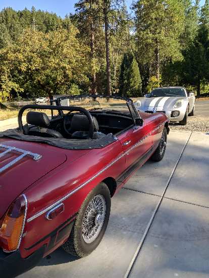 A red 1975 MGB with a silver Pontiac Solstice GXP.