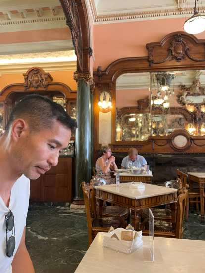 Felix inside the Majestic Café in Porto, a historic café from the Art Nouveau period.