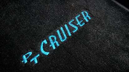 black PT Cruiser floor mat, blue letters