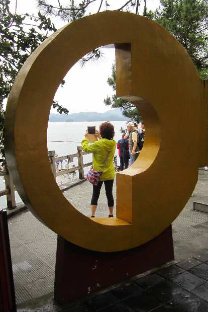A giant key frames a tourist taking a photo.