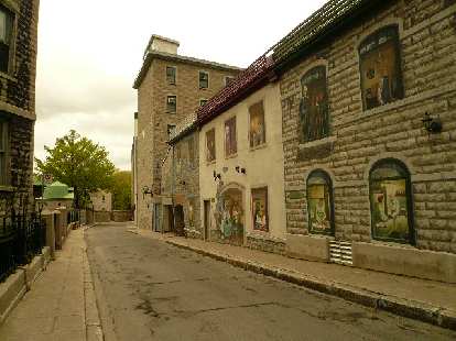 Photo: beige brick building, narrow street, Quebec City