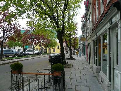 Sidewalk paved with rectangular pavers along storefronts in Quebec City. Sidewalk paved with rectangular pavers along storefronts in Quebec City.