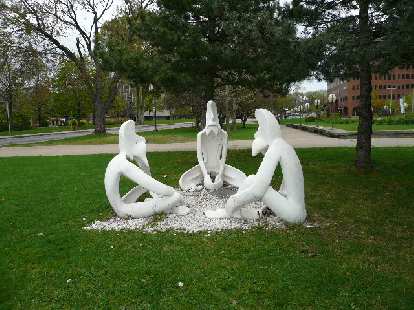 Photo: White art sculpture of three sitting humans in Quebec City.