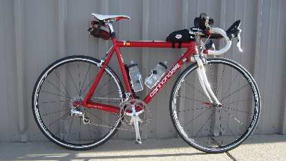 Photo: Red Cannondale 3.0 road bike, white saddle and fork, aerobars