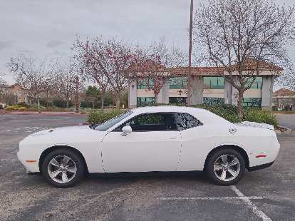Side view of a white 2019 Dodge Challenger SXT.