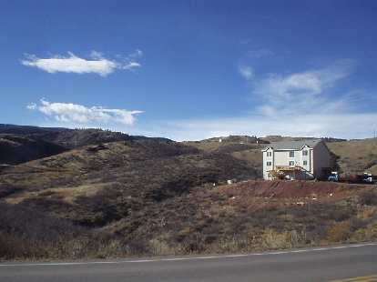A solitary home southwest of the Horsetooth Mountains.