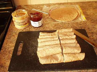 [Day before the brevet] Making a bunch of tortilla rollups with peanut butter and strawberry preserves.  Also made oatmeal raisin cookies and packed some fig bars.