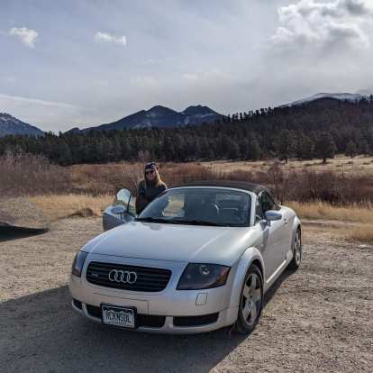 Andrea with my silver Audi TT Roadster Quattro with the Rocky Mountains in the background.