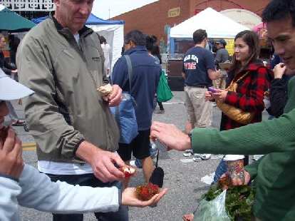 Eating Rambutans grown in Palm Desert at the Palo Alto Farmers' Market.