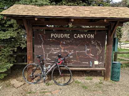 Mile 44: My Litespeed Archon C2 in front of a map of the Poudre Canyon in Rustic, Colorado.