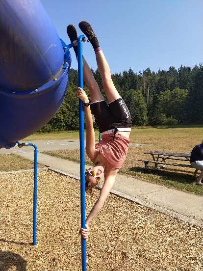 Erin being a vertical flag on playground equipment at Salt Creek County Park.