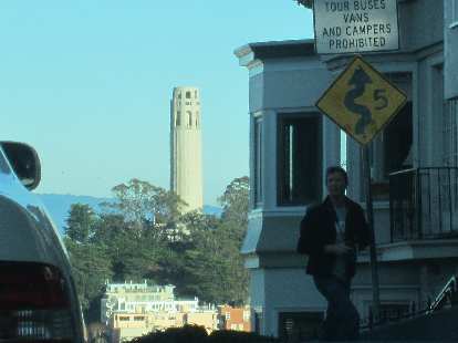 Coit Tower and a sign for the switchbacks of Lombard St.
