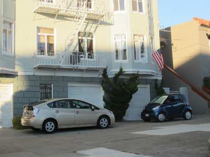 The poster cars of S.F.: a Toyota Prius and Smart car.
