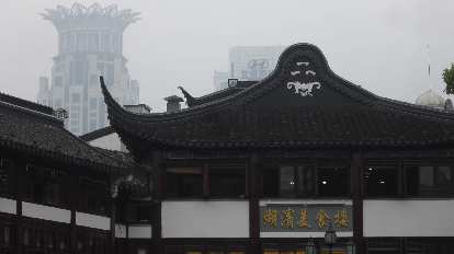 Building in the Town God's Temple area, with the top of the Bund Center in the background.