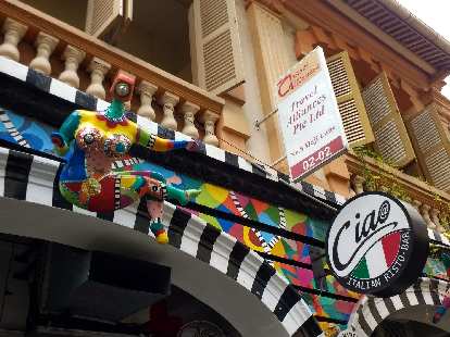 A colorful statue above Ciao Italian Risto-Bar on Haji Lane in Singapore. A colorful statue above Ciao Italian Risto-Bar on Haji Lane in Singapore.