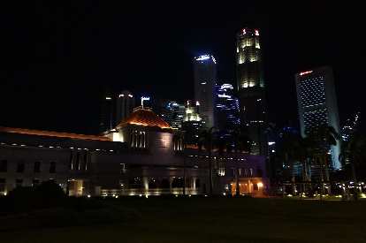 The Parliament building in Singapore at night.