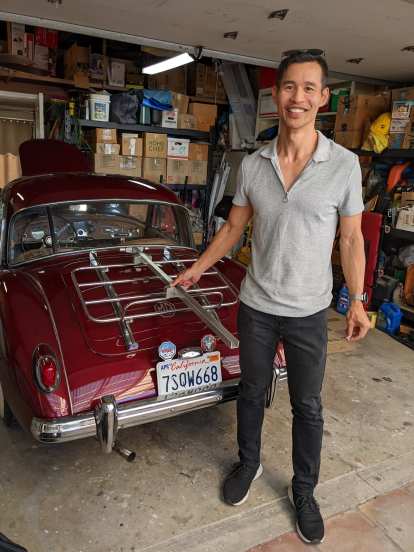 Felix Wong with a bicycle rack he designed and manufactured at Stanford University in 1996. It was designed for his MGB, but now Dan Shockey has it for use with his MGA.