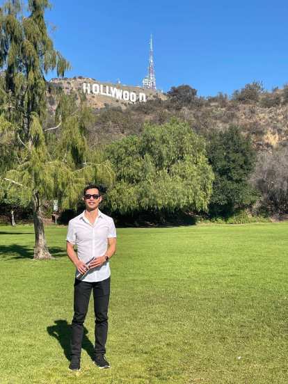 Felix Wong at Lake Hollywood Park with the iconic Hollywood sign behind.