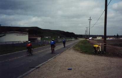 Some other cyclists during the 2000 Solvang Double Century, including Zach Kaplan readying his Festina recumbent bicycle. four cyclists, Zach Kaplan readying his Festina recumbent bicycle, 2000 Solvang Double Century