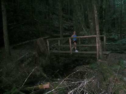 Lisa running over a bridge.