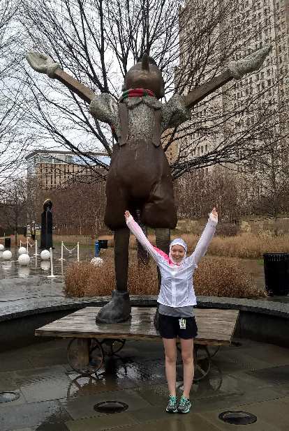 Maureen mimicking the victory salute of a statue at Citygarden. Maureen, arms raised, statue, Citygarden