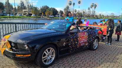 Sylvia Wong, Citizen of the Year, in the black Mustang convertible used in the 2017 Stockton Chinese New Year parade.