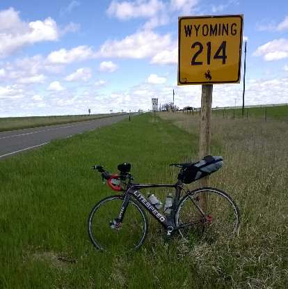 My black 2010 Litespeed Archon C2 in front of a yellow sign in Wyoming during my Fort Collins-Nebraska 200 training ride. (24 May 2015) black 2010 Litespeed Archon C2, yellow Wyoming 214 sign