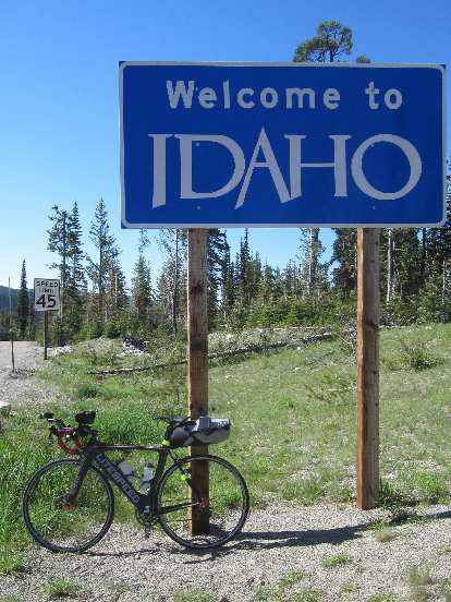 My black 2010 Litespeed Archon C2 in front of a Welcome to Idaho sign during the 2015 Trans Am Bike Race. (11 Jun 2015) black 2010 Litespeed Archon C2, Welcome to Idaho sign