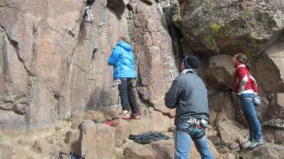 Jordan and Erika on belay with Scott looking on.