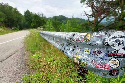 Bumper stickers on a guard rail near a scenic overlook off the Tail of the Dragon on Rt. 129.