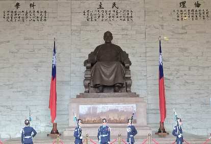 Changing of the guard in front of a giant statue of Chiang Kai-shek.