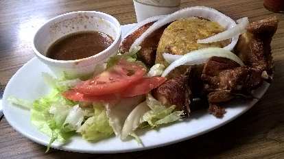 Mofongo (Puerto Rican plantains), chicken, and salad at La Lechonera in Tampa, Florida.