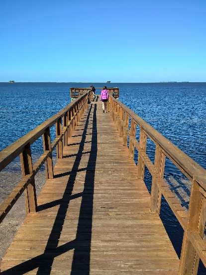 Maureen walking along the Wesley S. Henry Community Pier in Palm Harbor, Florida.