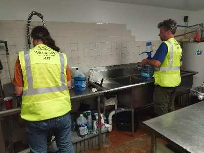 Matt Hannifin and Nate Faudel (both RV drivers for Team Sea to See) helping wash dishes inside the kitchen of a random restaurant in Pagosa Springs. (19 Jun 2018) Matt Hannifin and Nate Faudel (both RV drivers for Team Sea to See) helping wash dishes inside the kitchen of a random restaurant in Pagosa Springs.