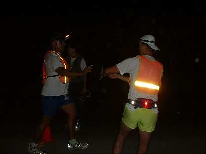 Herb makes a handoff to Steve during the darkness on his 2nd leg. Photo: Tom Erceg. (12 Oct 2003) Herb makes a handoff to Steve during the darkness on his 2nd leg.