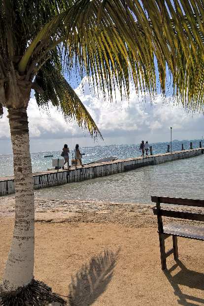 tourists walking along pier outside Tortungranja in Isla Mujeres