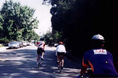 Three Stanford cyclists ride through Saratoga during the 1998 Tour du Jour. three Stanford cyclists, Saratoga, 1998 Tour du Jour