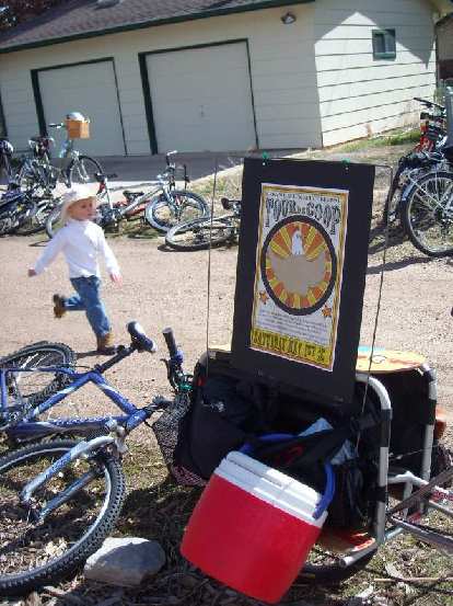 A boy running by bikes and the Tour de Coop sign.