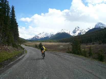 Day 1: Riding mostly uphill by the Canadian Rockies with fellow racer Kevin Hall (shown).