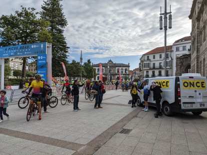 Cyclists and an ONCE support van at the start of 4 Picos Road Pontevedra