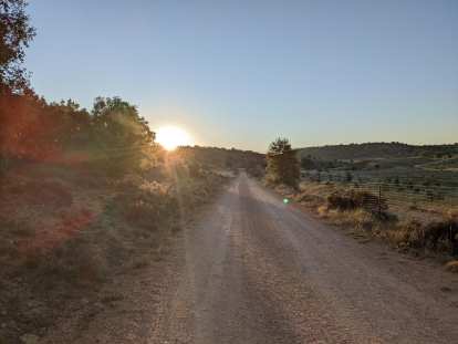I was greeted by a sunrise over a gravel road while doing my daily morning run.